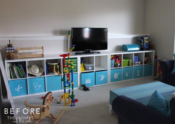 playroom with toys organized in a wall-length storage cubby unit.