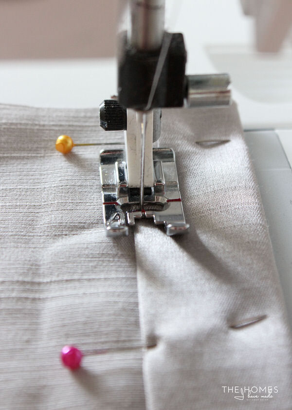 a piece of fabric is guided through a sewing machine.