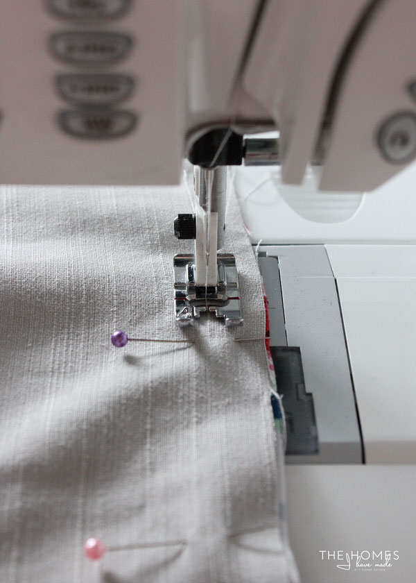 a piece of fabric is guided through a sewing machine