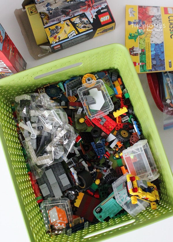A green basked filled with lego pieces