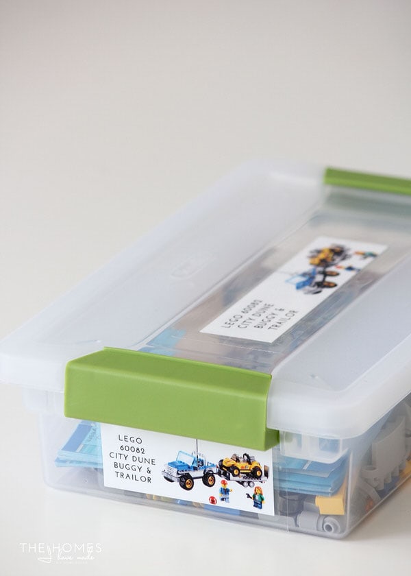 Photo of a clear bin containing Lego pieces and labels on both the top and side of the bin