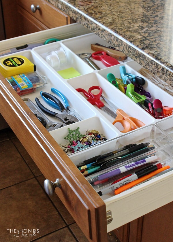 White plastic drawer dividers help keep a junk drawer tidy