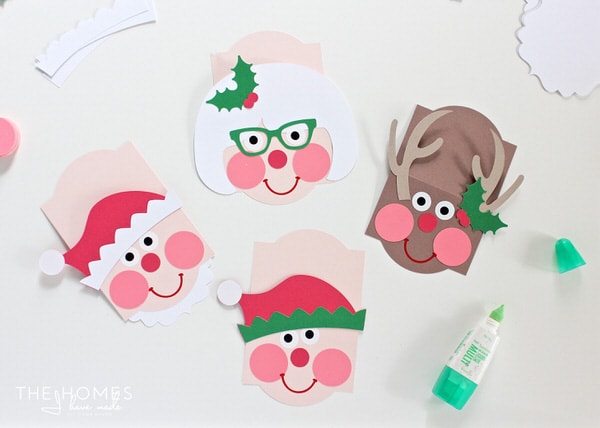 Top of a bag of treats for everyone on your list with these adorable Christmas Character Treat Bag Toppers - made with paper and the Cricut Explore!