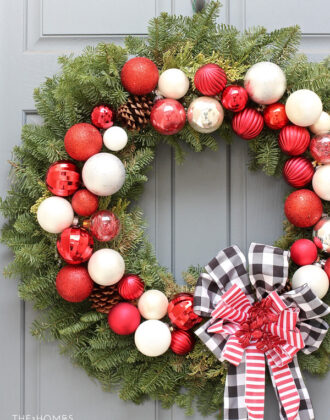 Looking for a classic take on your Christmas decor this year? Check out this holiday porch decked out in classic red, white, and black for a charming display!