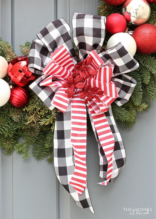Looking for a classic take on your Christmas decor this year? Check out this holiday porch decked out in classic red, white, and black for a charming display!