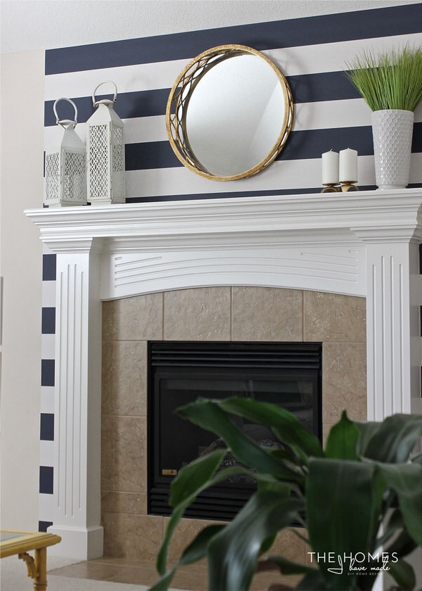 A feature wall around a fireplace with removable wallpaper