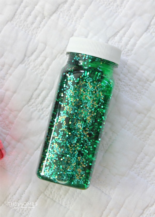 It's fun and easy to make DIY Sensory Bottles for baby using medicine bottles, beads, glitter and water!