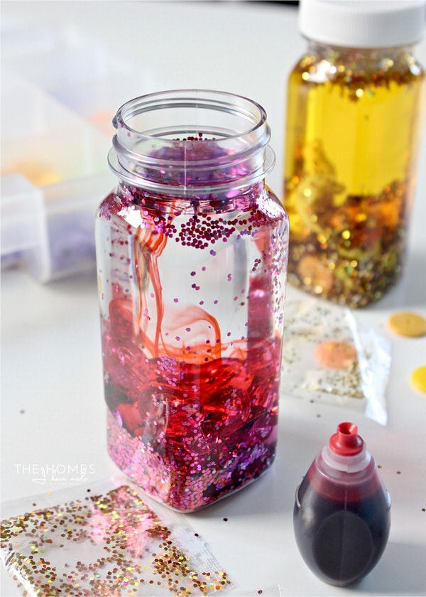 It's fun and easy to make DIY Sensory Bottles for baby using medicine bottles, beads, glitter and water!
