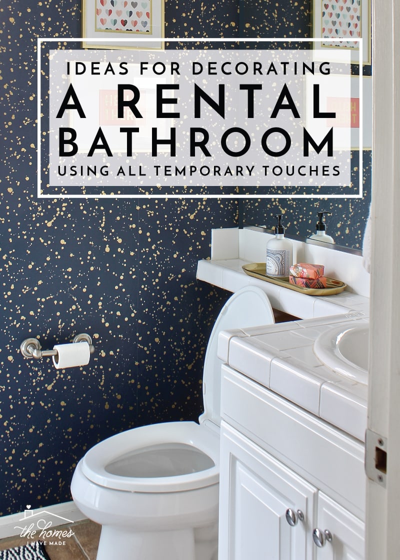 A rental bathroom with gold splatter wallpaper and gold and salmon bathroom accents with text overlay