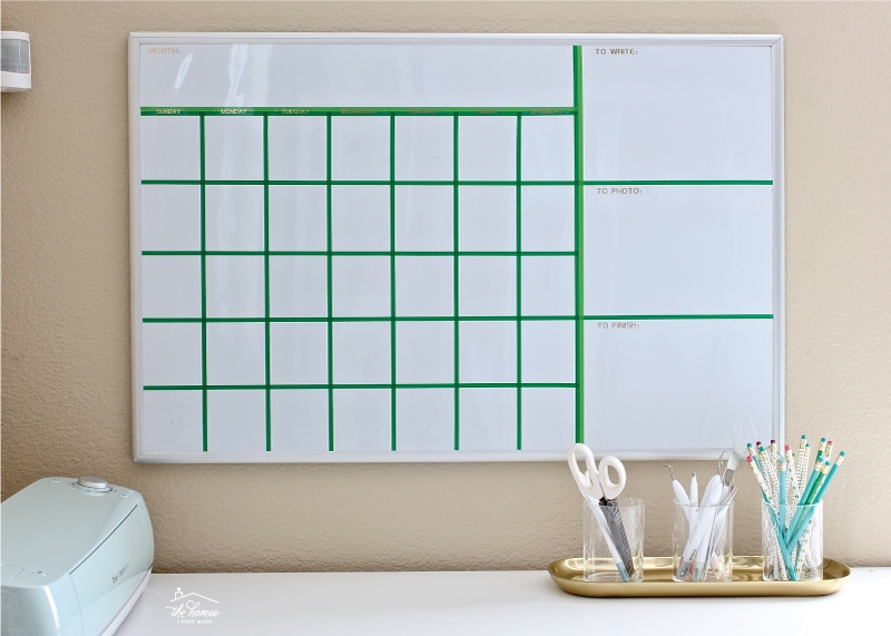 A dry-erase board calendar with grid lines made from washi tape