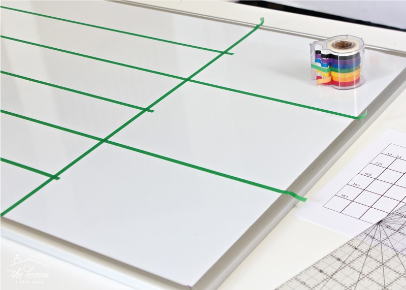 A dry-erase board calendar with grid lines made from washi tape