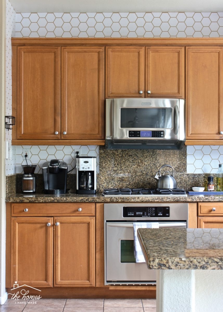 Adding pattern to your kitchen backsplash doesn't have to require tile! This tutorial shows you exactly how to wallpaper a backsplash for that pop of pattern your craving!