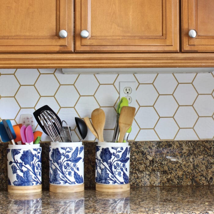 Adding pattern to your kitchen backsplash doesn't have to require tile! This tutorial shows you exactly how to wallpaper a backsplash for that pop of pattern your craving!