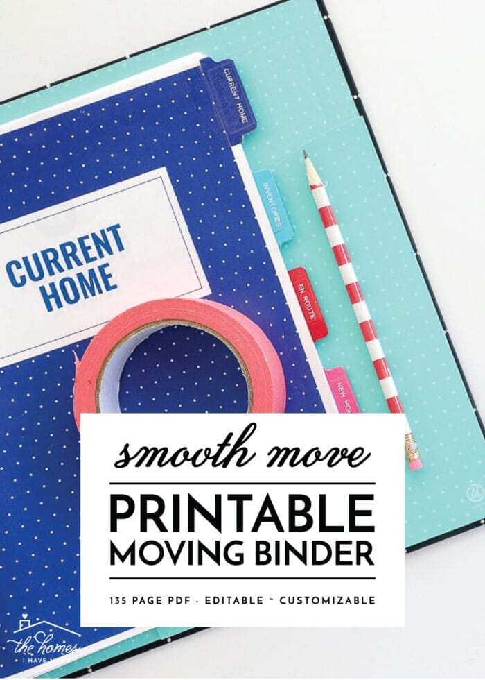 Printable Moving Binder opened on a white desk with the Current Home section showing and a clipboard with an inventory key.