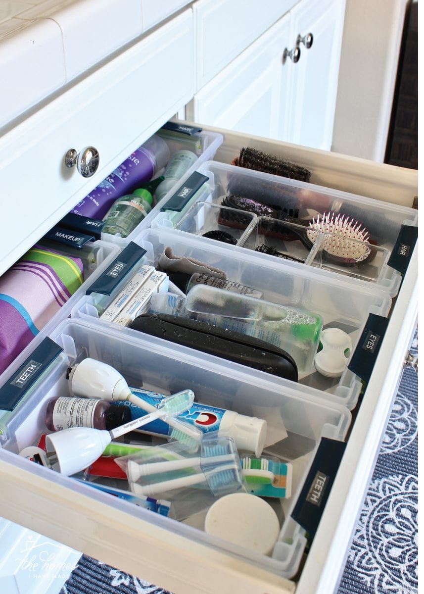 Organized bathroom drawers with Sterilite bins.