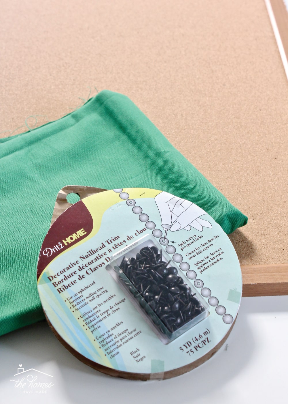 Give a basic bulletin board an easy, inexpensive and stylish upgrade with fabric and nailhead trim!
