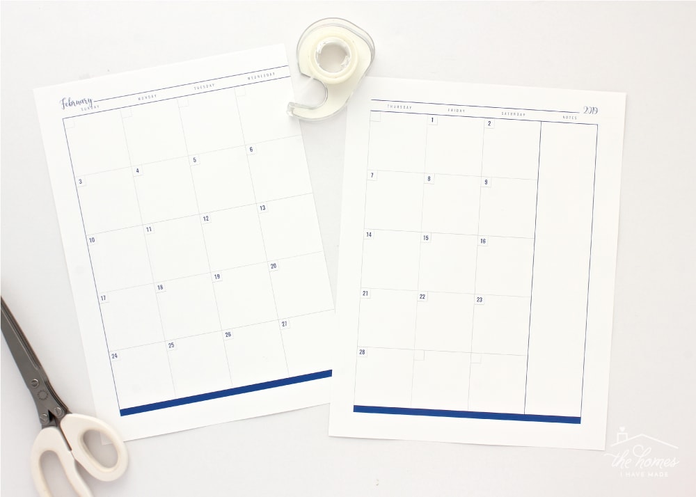 Two-page blank monthly calendar spread assembly with tape and scissors.