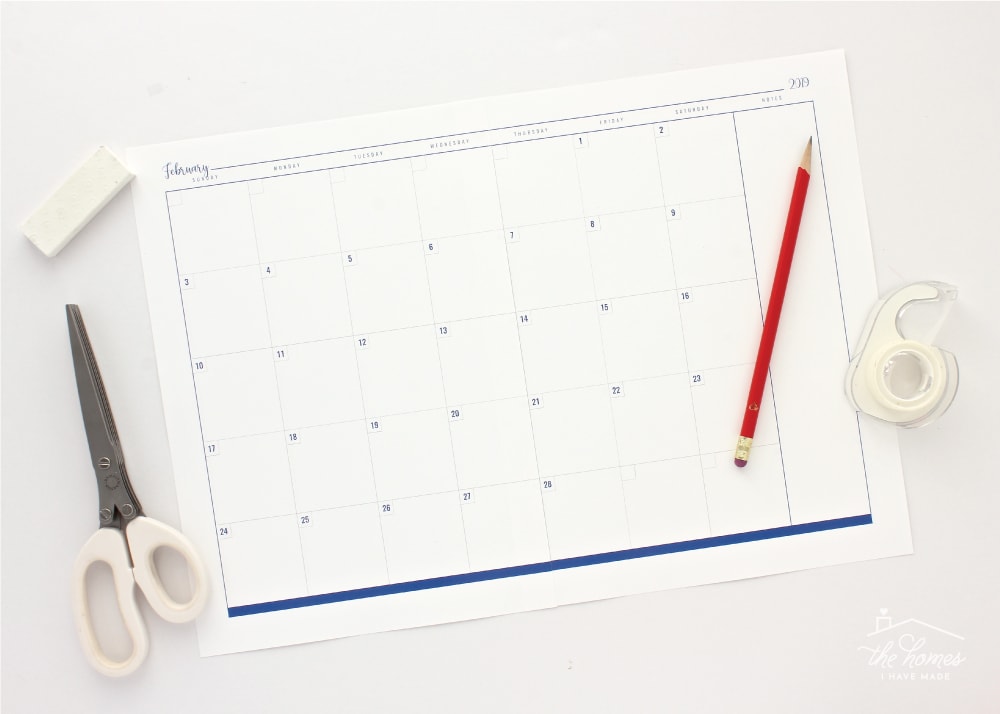 Two-page blank monthly calendar spread assembled with tape and scissors.