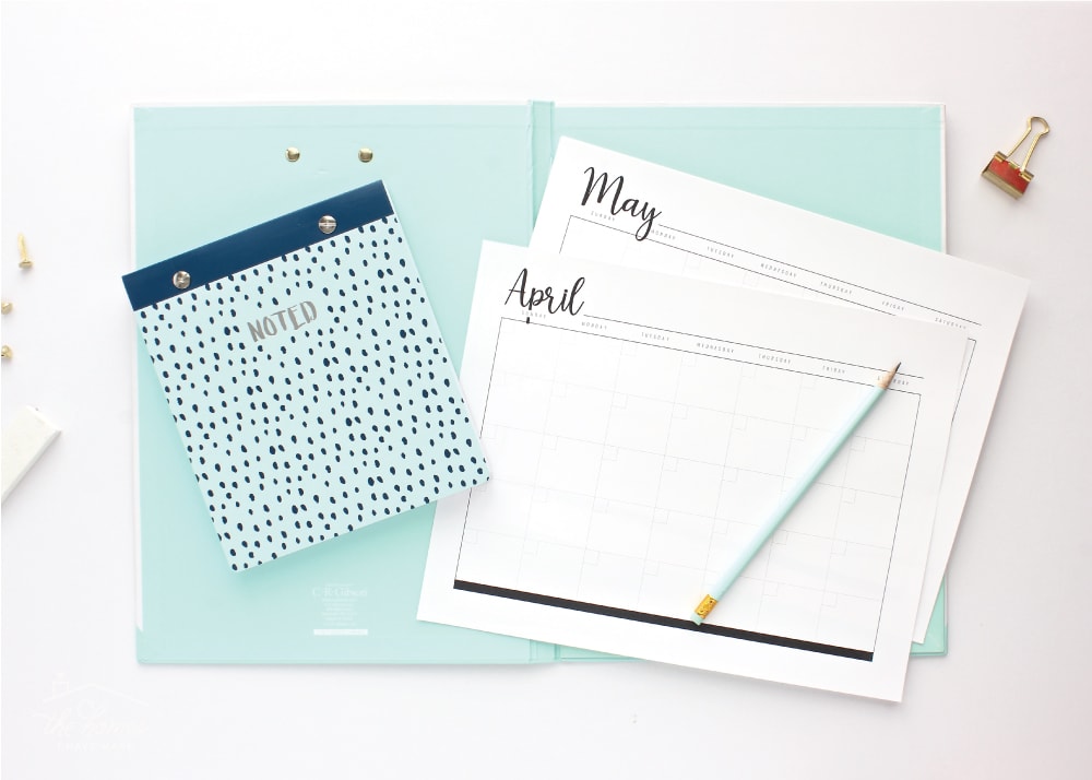 Black and white printable blank monthly calendar pages on a light blue folder.