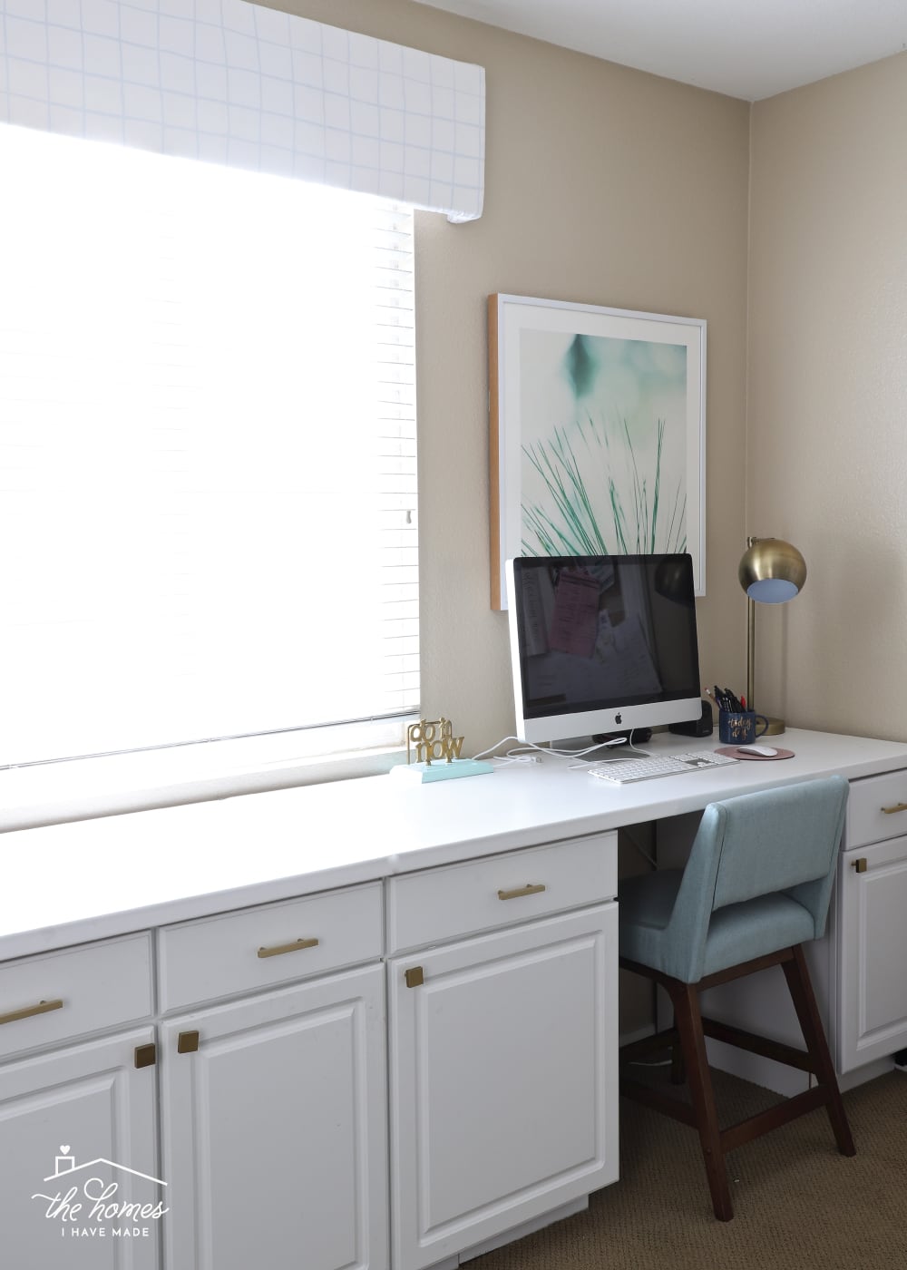 a white window valence hanging in a home office.