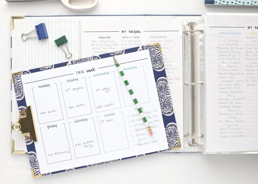 A printable meal plan on a blue clipboard shown alongside a Recipe Binder