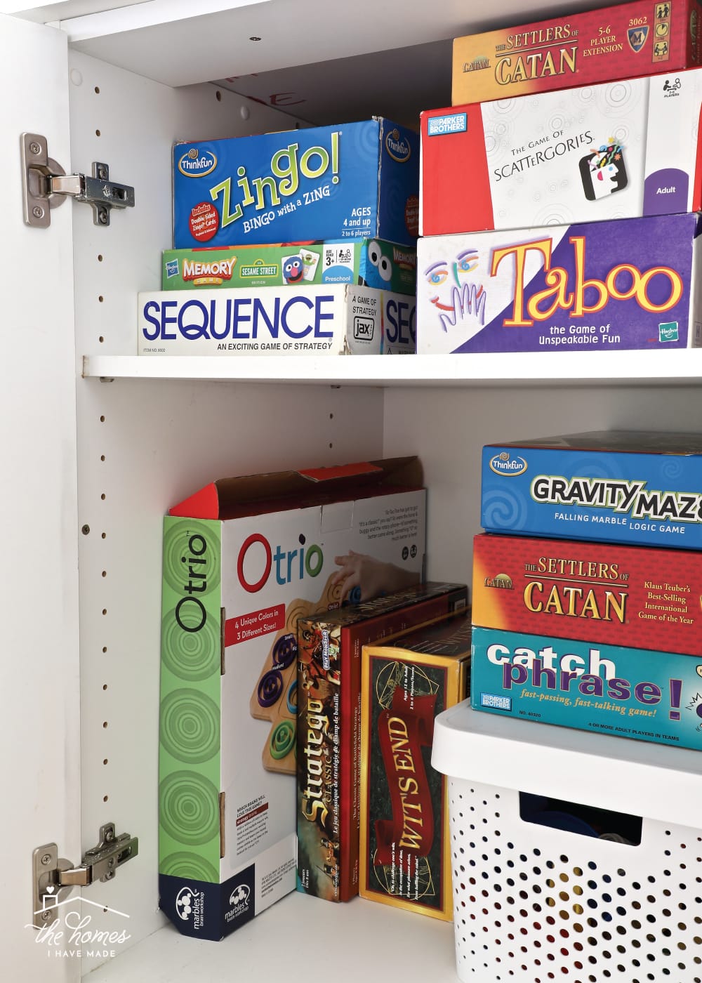 Vertical image of board games organized inside a cabinet