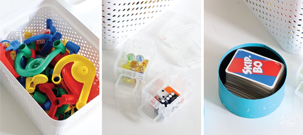 Series of three vertical images of open containers with game board pieces inside 