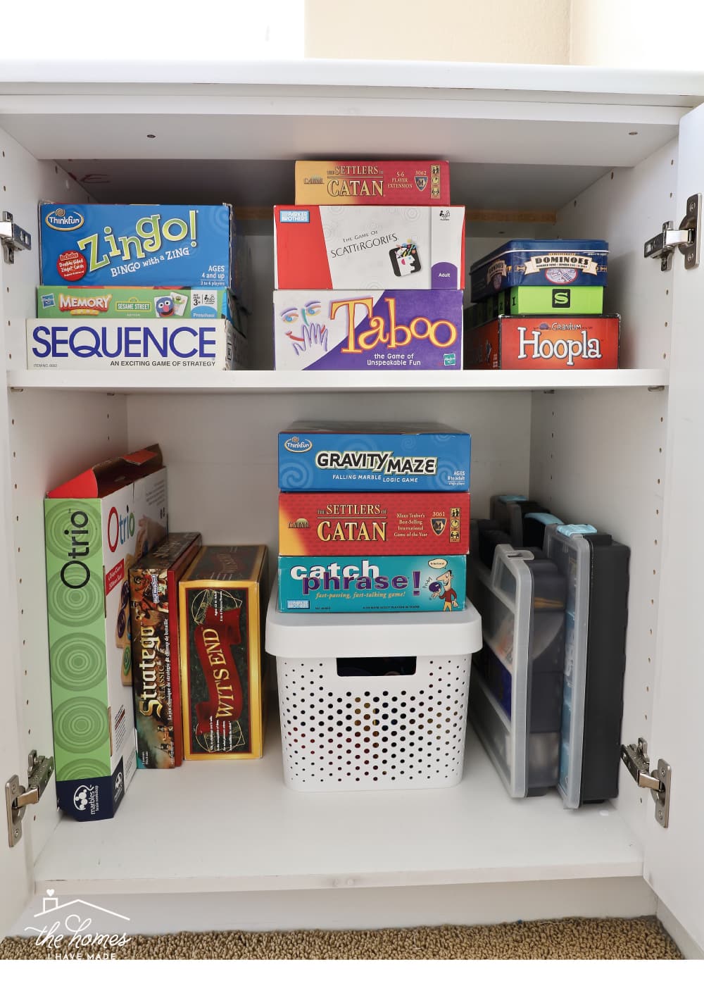 Vertical image of board games stacked inside a cabinet
