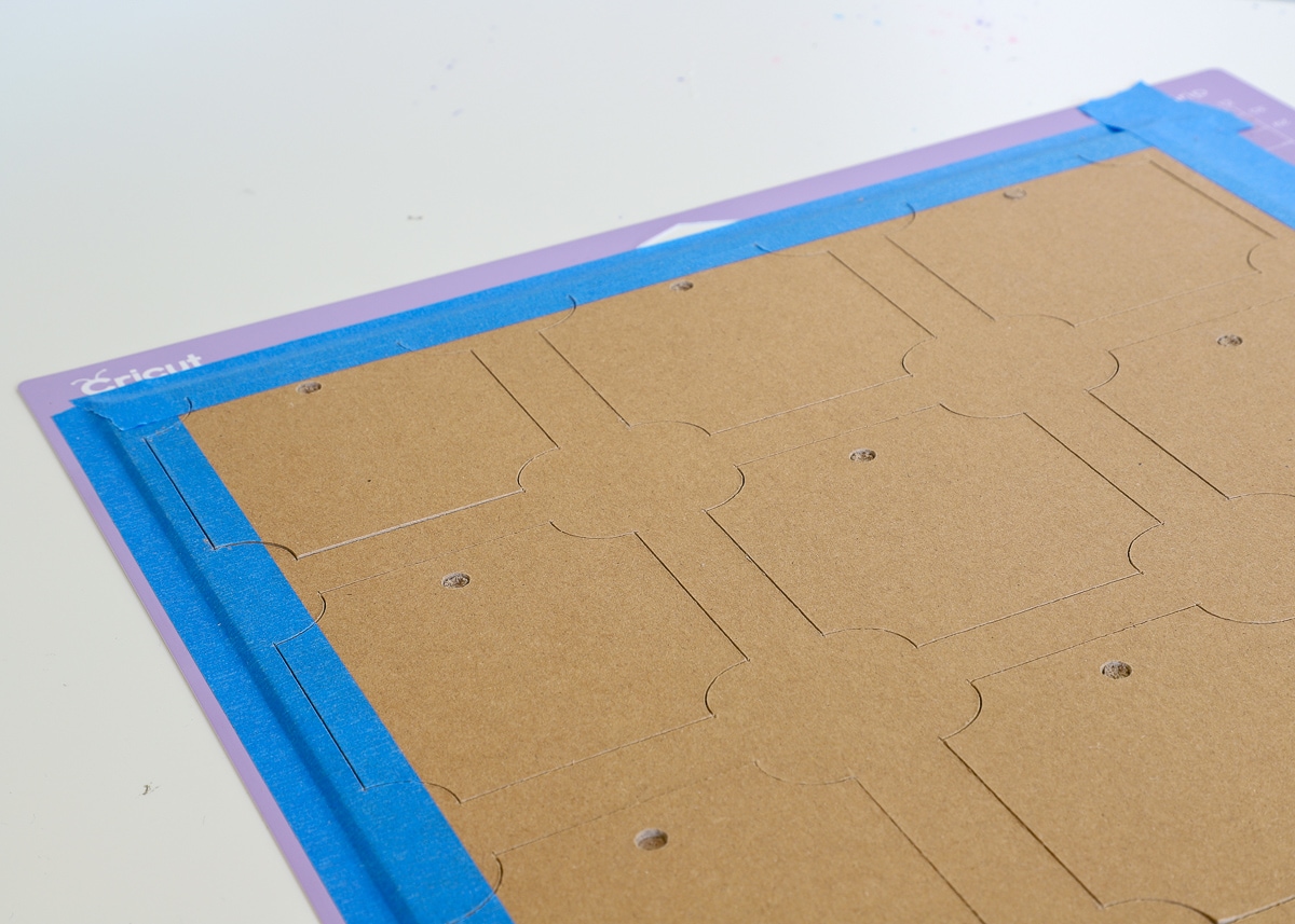 Chipboard labels on a mat cut with a Cricut Maker