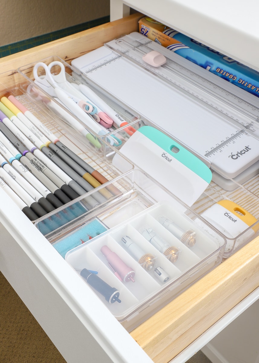 A drawer full of office items organized with off-the-shelf drawer organizers