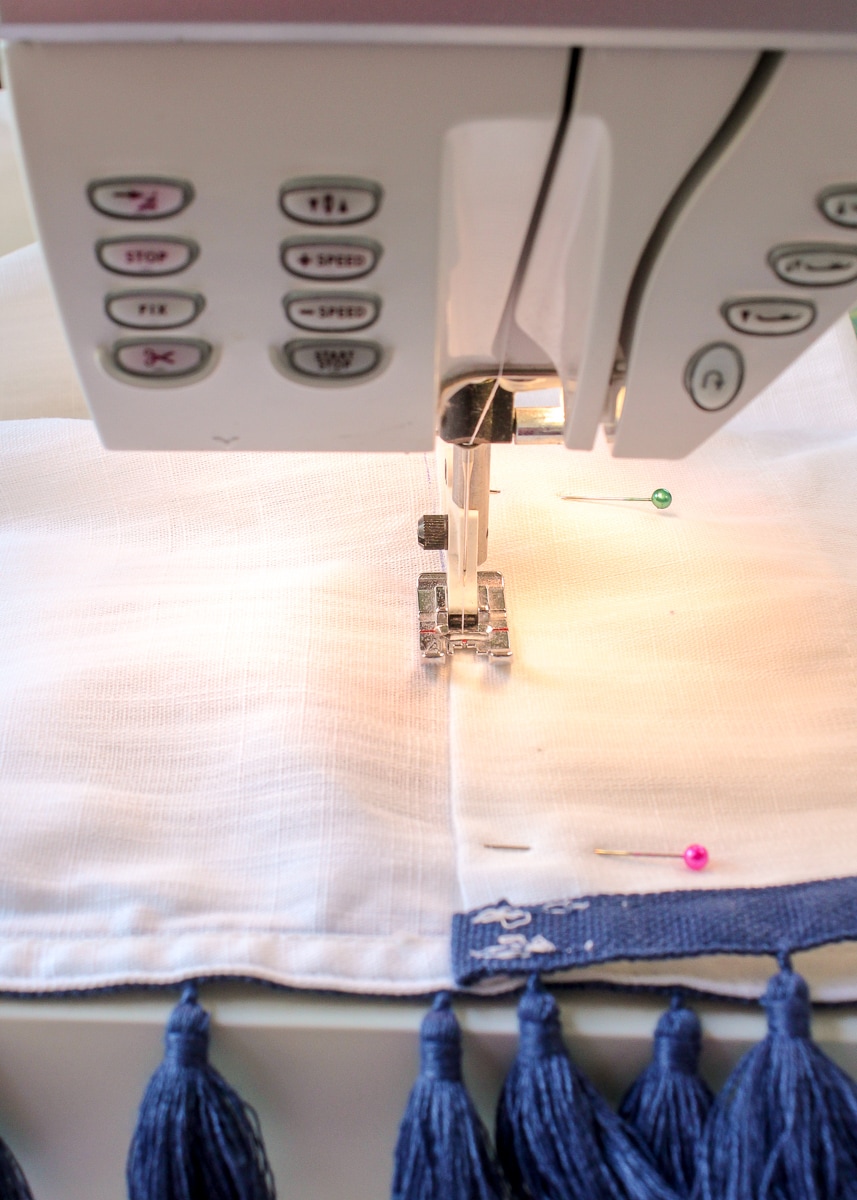 sewing a curtain hem in a sewing machine.