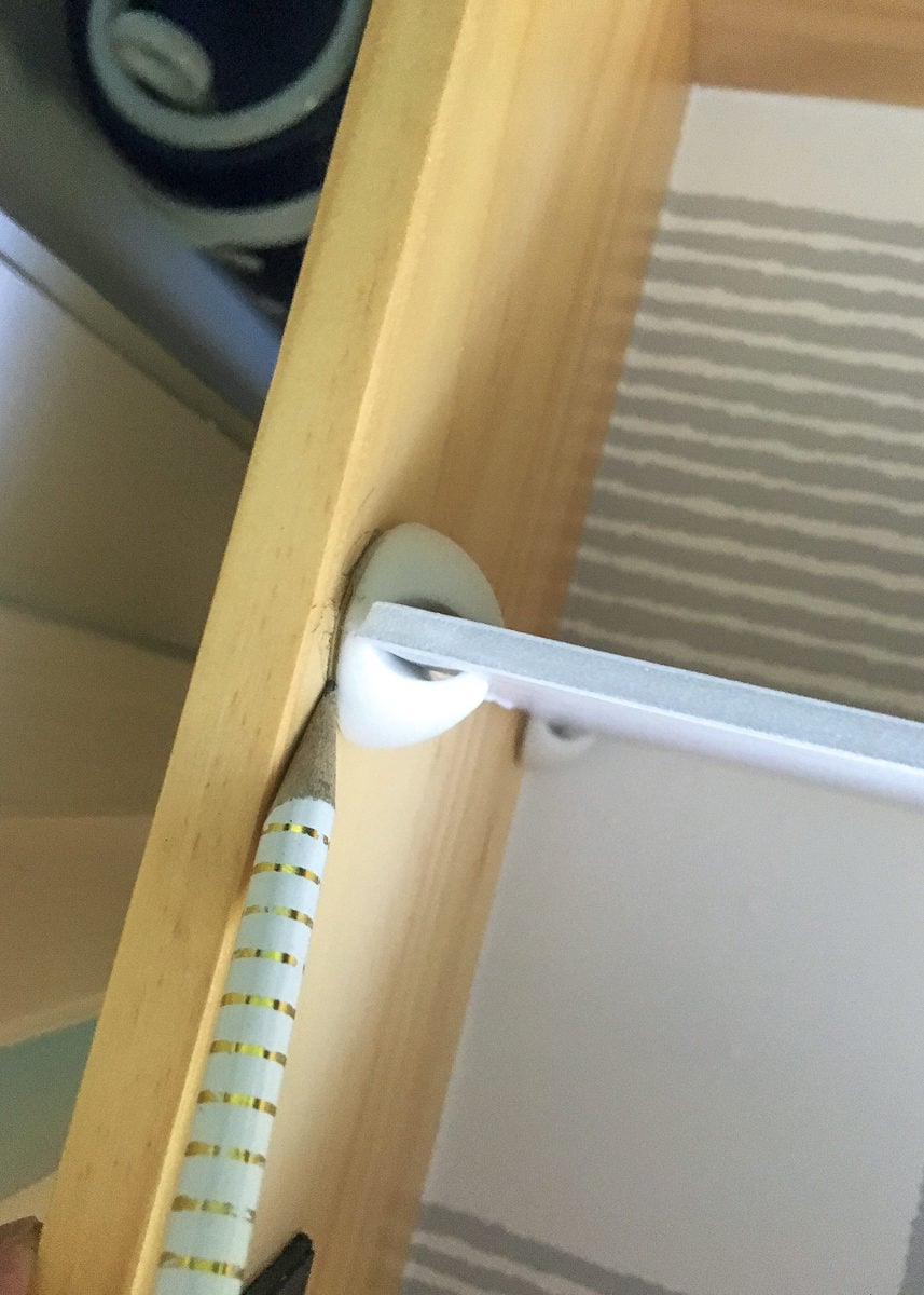 Pencil marking cable clip location inside drawer