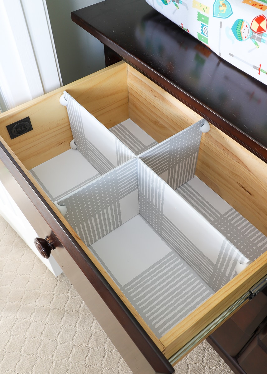 Decorative drawer dividers secured inside a drawer with cable clips