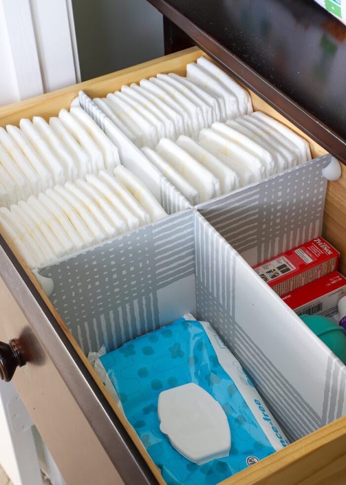 DIY Drawer Dividers inside a nursery drawer holding diapers and wipes