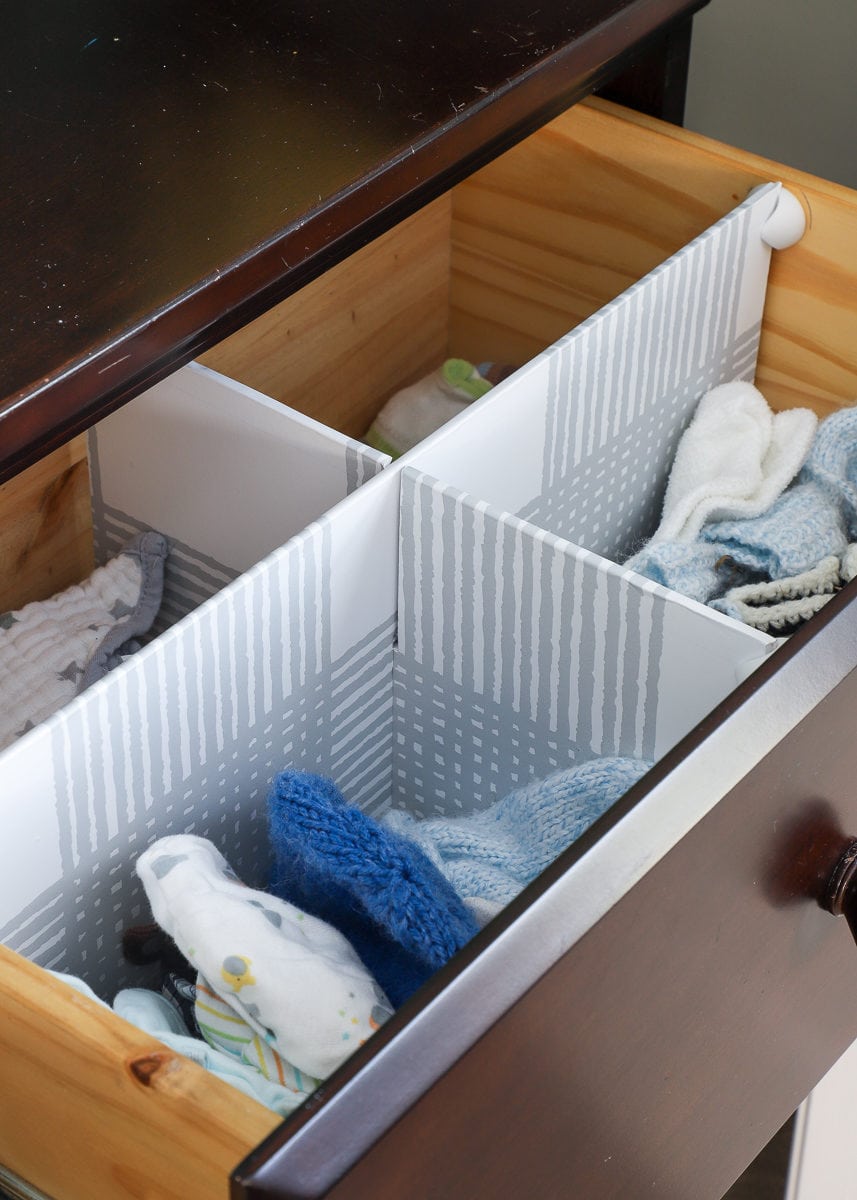 DIY Drawer Dividers inside a nursery drawer holding hats, burp clothes, and socks