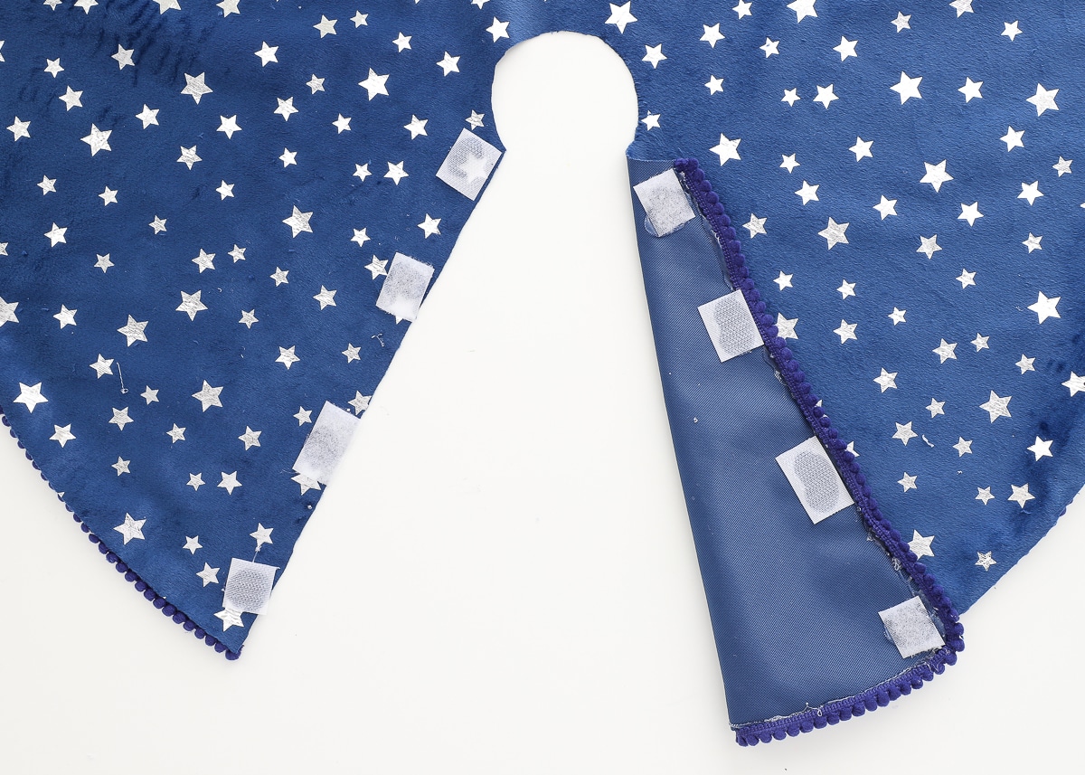 Navy blue Christmas tree skirt with Velcro tabs.