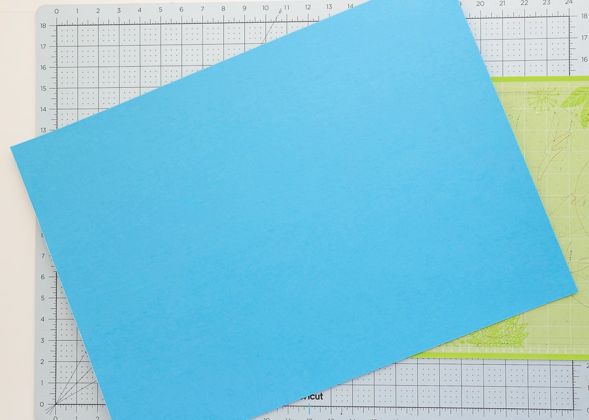 Cardstock paper, a Cricut cutting mat and a standard grip mat