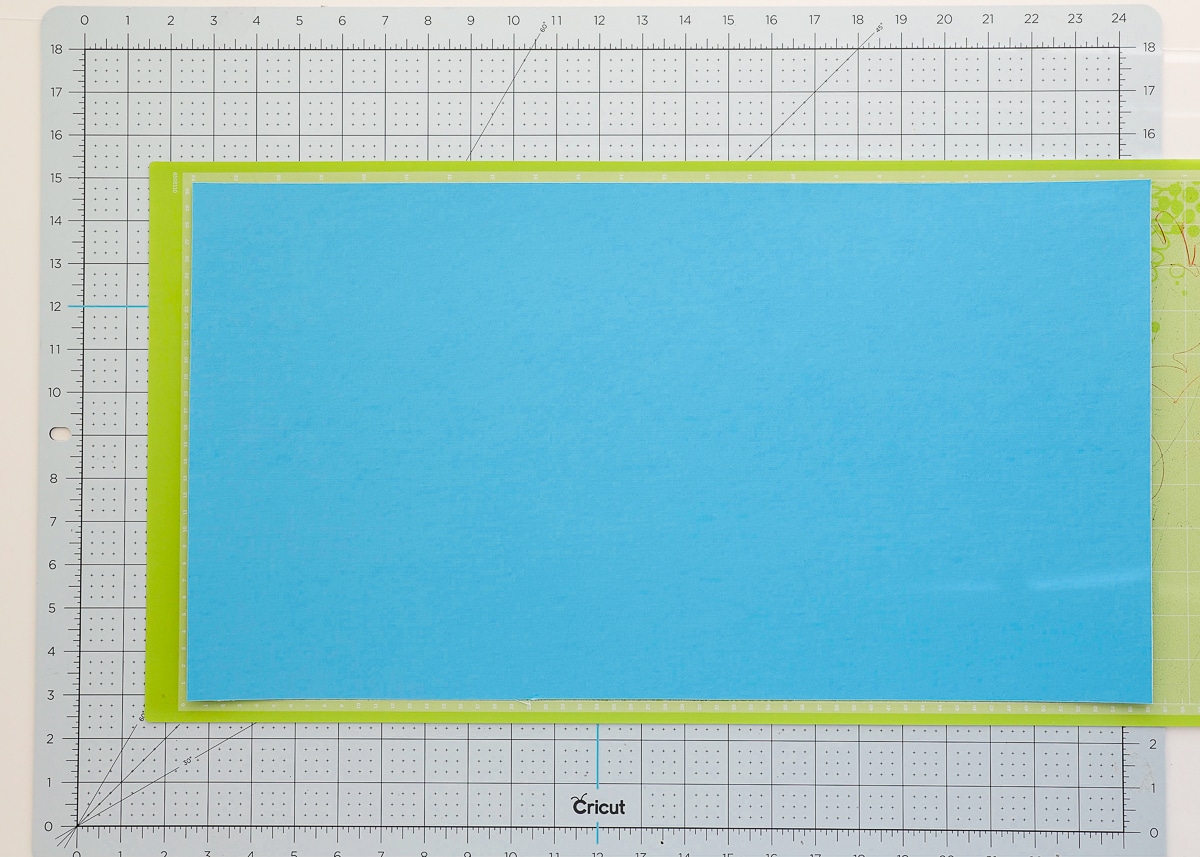 Cardstock paper, a Cricut cutting mat and a standard grip mat