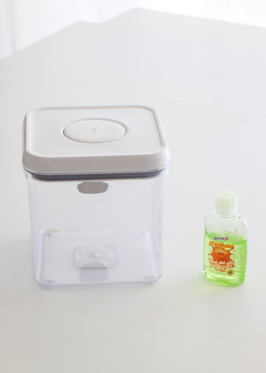 A clear, clean container next to hand sanitizer