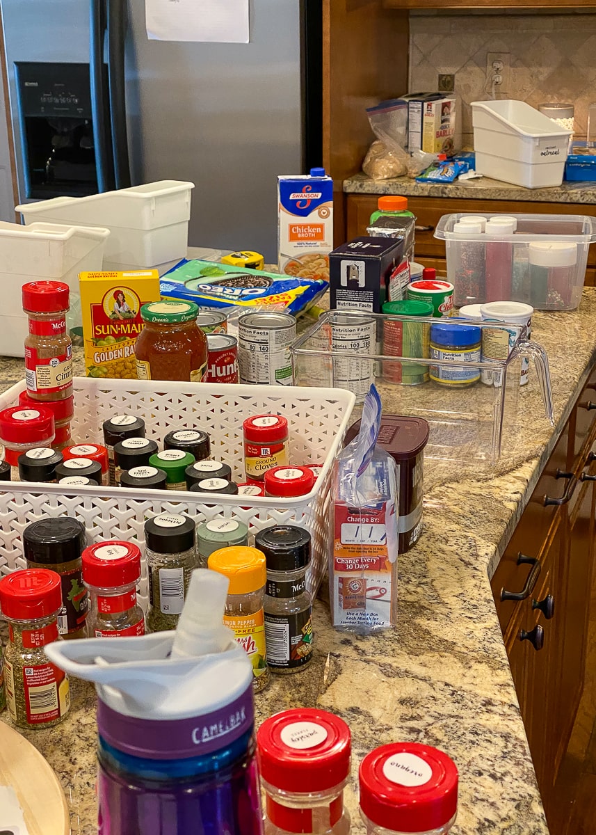 pantry items are spread out across a kitchen countertop