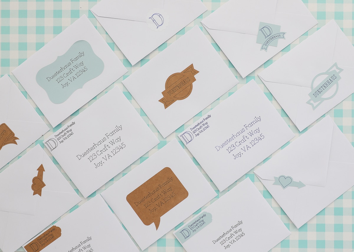 Envelopes with Cricut-designed address labels, stickers, and decor