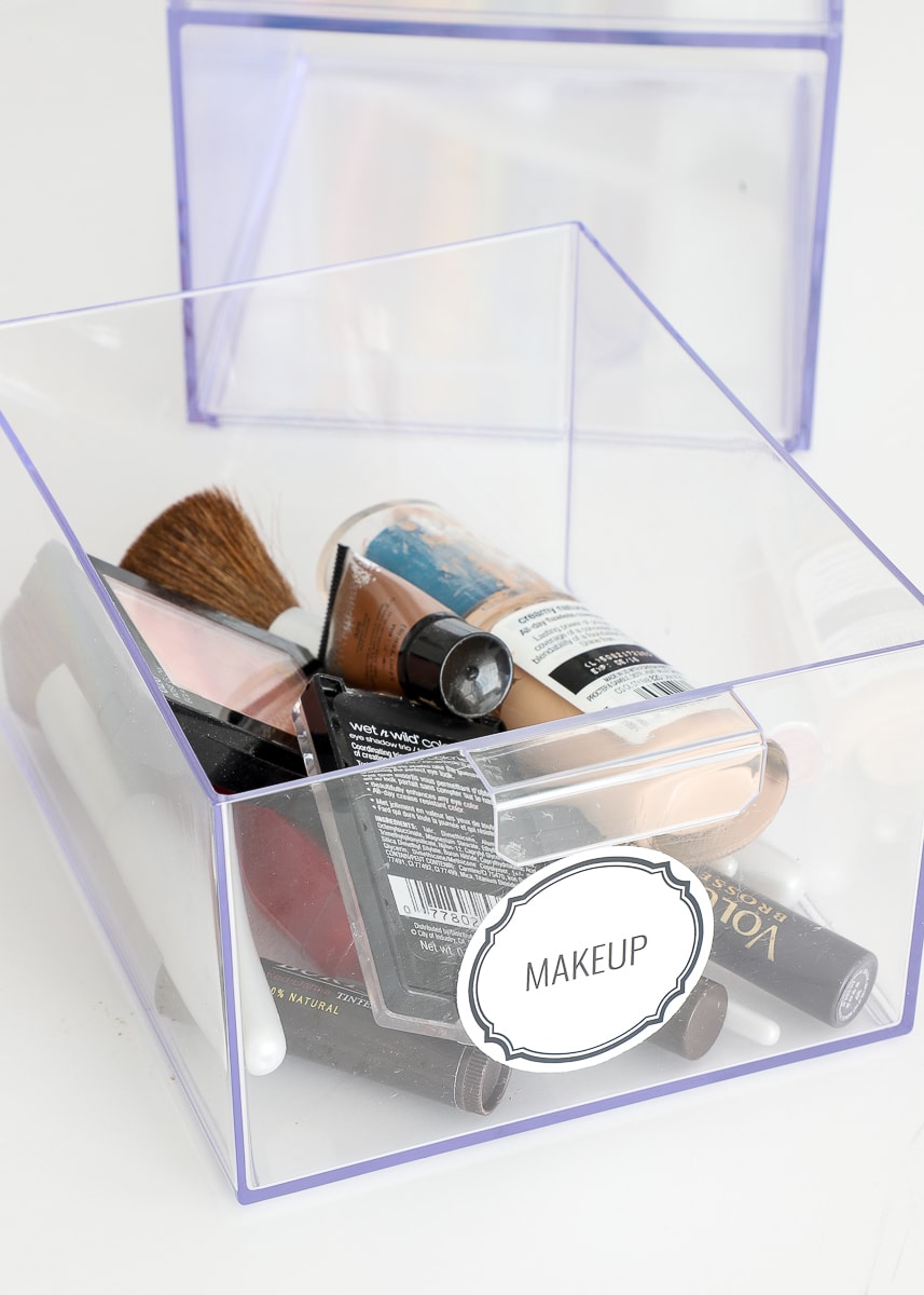 A clear labeled drawer with makeup 
