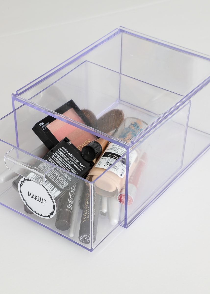 A clear labeled drawer with makeup 