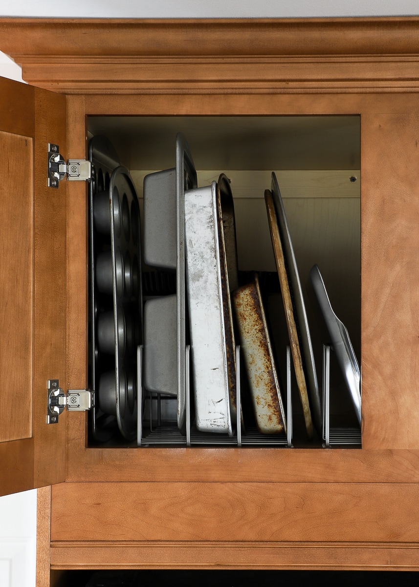 A cabinet with cookware organized inside