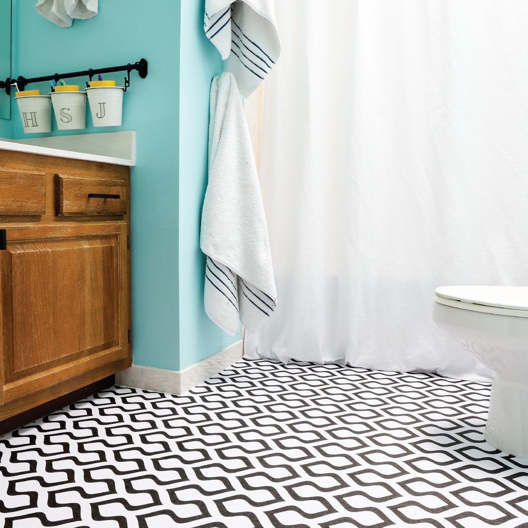 Black and white peel and stick wallpaper on a floor in bathroom