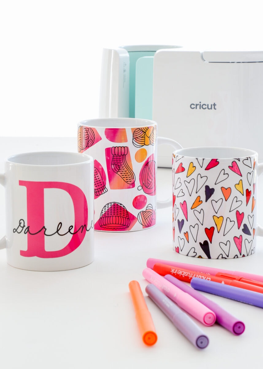 Personalized mugs made with a Cricut machine.