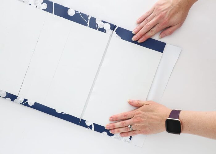 this simple foam window valance is wrapped in pretty blue wallpaper