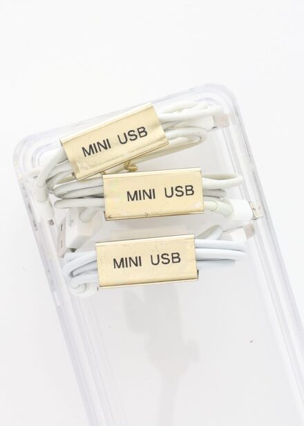 White cords organized and labeled with gold paperclips
