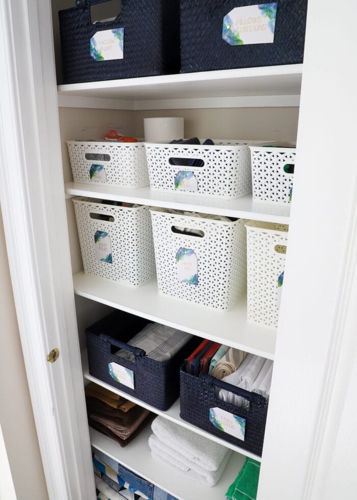 Sturdy baskets and gorgeous labels keep this linen closet perfectly organized.