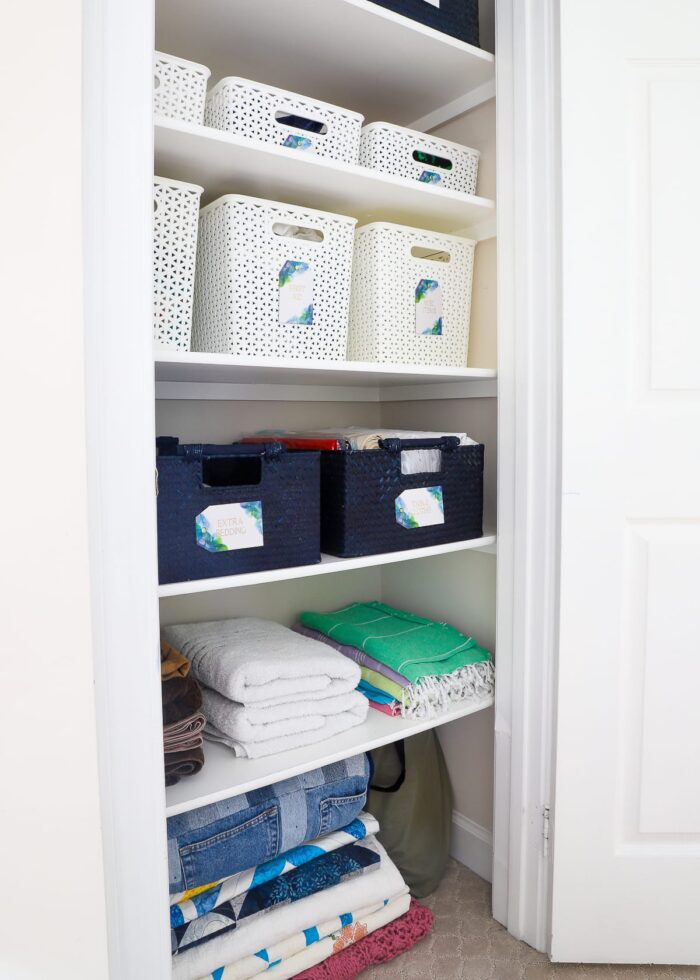 Sturdy baskets and gorgeous labels keep this linen closet perfectly organized.